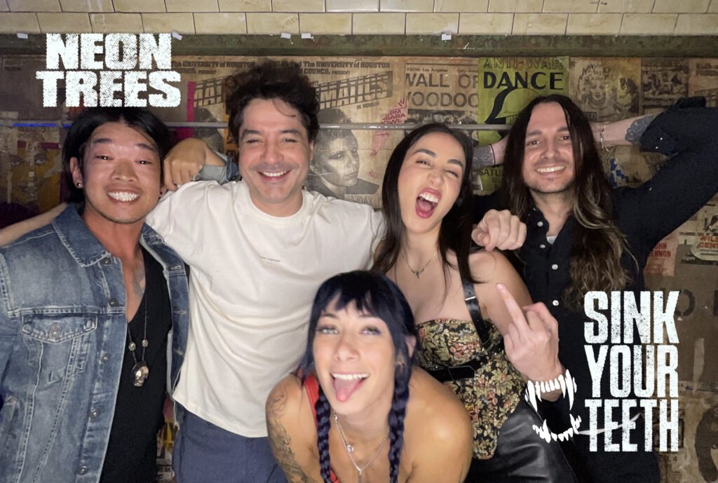 A group of friends taking a photo in a Hive Photo Booth at the Neon Trees Sink Your Teeth Event