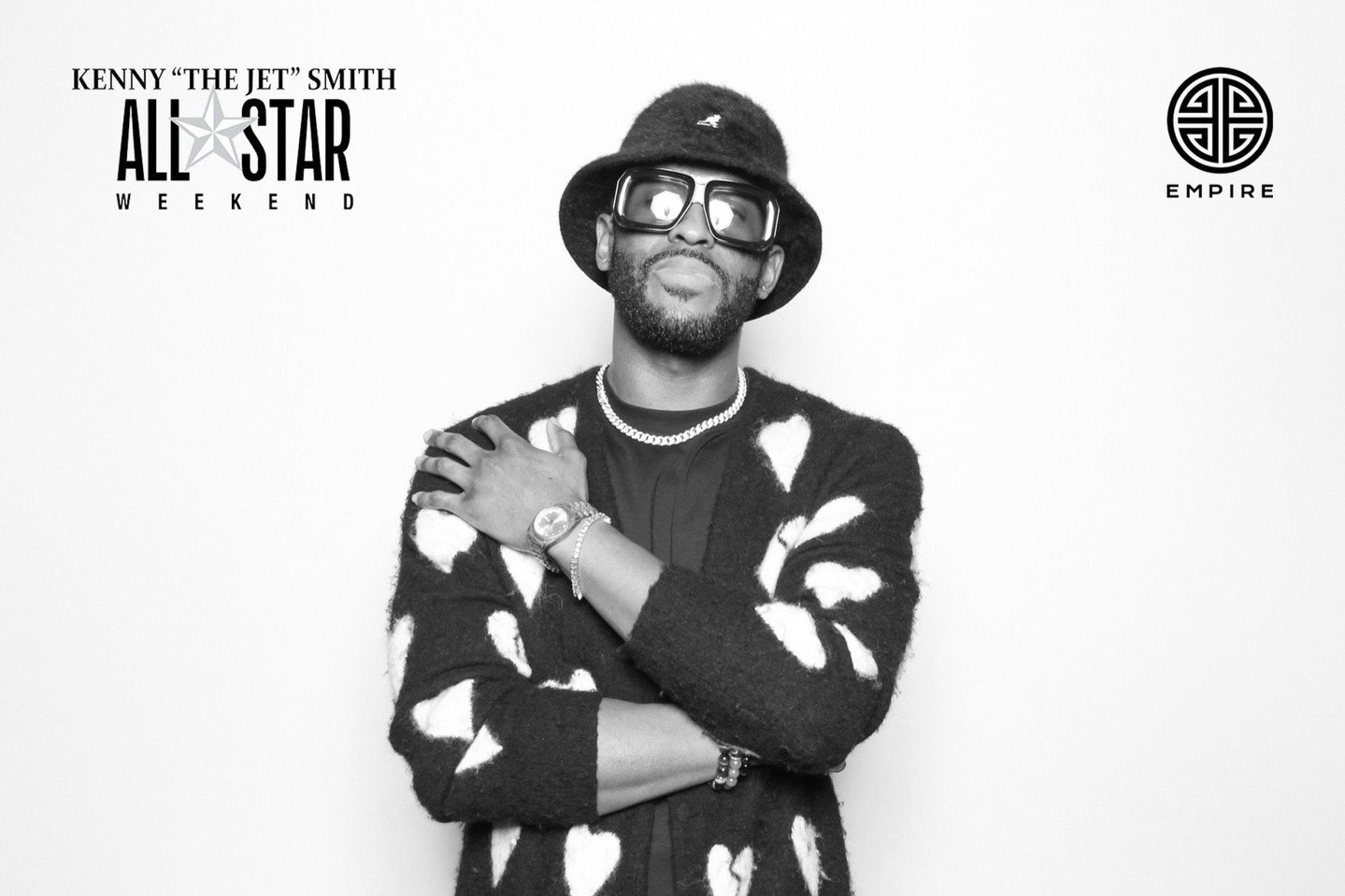 A guy taking a black and white photo from Captured at Empire Records x Kenny Smith's All Star Weekend