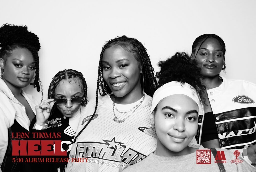 Leon Thomas “Heel” Album Release Party 1 Guests pose for a photo at the Interscope Records album release party at Avalon Hollywood, surrounded by vibrant nightclub lighting.