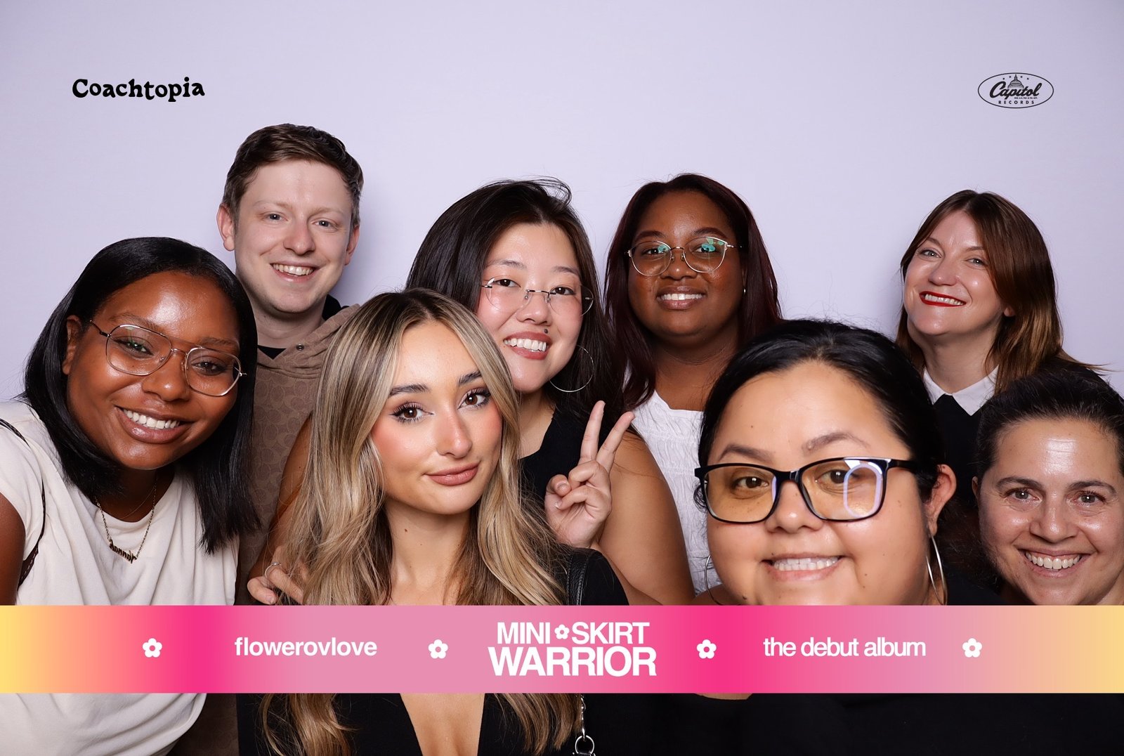 Group of guests posing in a branded photo booth at the Flowerovlove album release party in Los Angeles